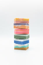 Load image into Gallery viewer, Stack of colorful soap bars on a blurred natural background