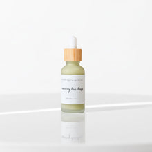 Load image into Gallery viewer, Bottle of serum with dropper on a reflective surface with wooden background